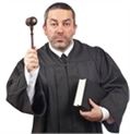 a judge holding a law book under his left arm and raising a gavel with his right hand